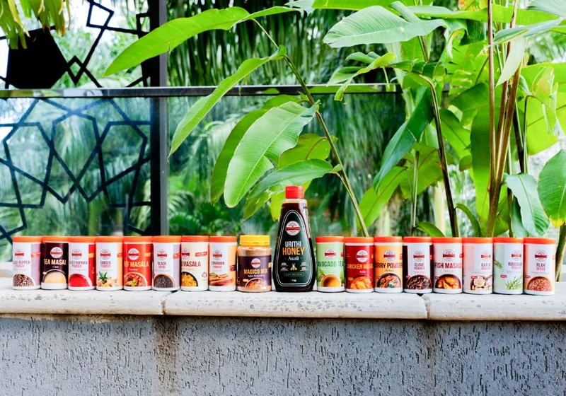 The Urithi Foods spice range along a ledge against Tanzanian greenery