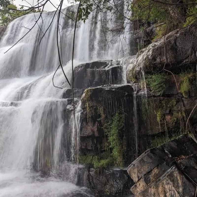 A waterfall framed by forest canopy at Mpanga-Kipengere Game Reserve